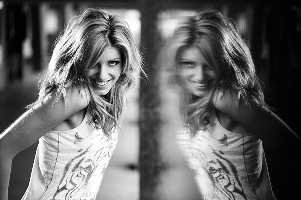 When I am using just one Speedlight I often rig it as a back light or kick light. This shot of Johanna and her reflection in a black granite column was lit with natural daylight from the front and a Speedlight from the back. I wanted to shoot with my 100mm lens wide open at f/2.8 in order to render the background out of focus. I used ISO 100 and a corresponding shutter speed of 1/200th second to correctly expose the ambient key light that lit Johanna. Messy hair and a fun moment complete the look of this character portrait.