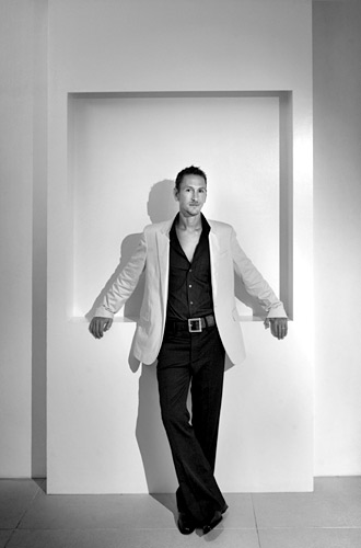 01_18 Here I created a pool of light for the groom to stand in and placed him right in the middle of the frame just breaking the symmetry with his crossed legs. I always use a monopod to hold the camera steady in these situations. ISO 400 f/4 at 1/11th