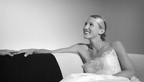 01_19 The touch of the hands and the look of love make this image work for me. The light position should have been to the left of the camera but because the barn doors kept the spill from creeping up the wall behind the bride, I got away with it. ISO 800 f/4 at 1/125th