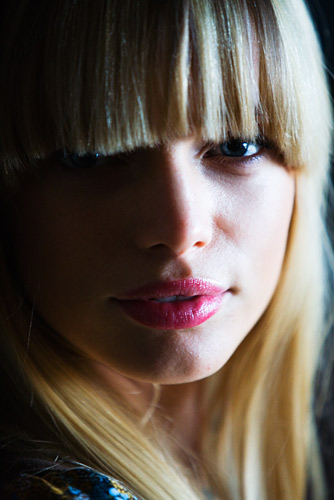 A lift of the face and the mood. Rim lighting from a distant window adds the depth in the image.