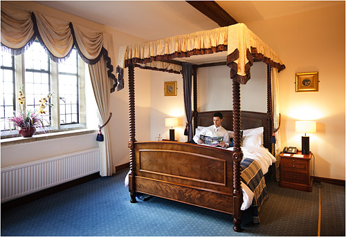 This is the 'money' shot. It shows the 4 poster bed and the room. The money shot is a term from the film industry for a scene setter that shows off the set design and props.