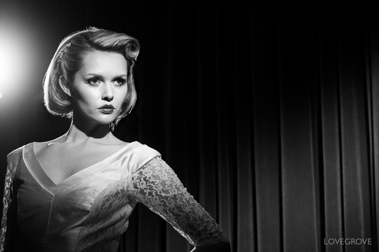 Just a pair of curtains as a background and a pair of Lupolux LED 650s give Carla Monaco that classic film star look. Note the vintage neck line to her dress and the curls in her hair. Carla’s cheekbone is emphasised with a strong shadow created by using a ‘down the nose’ key light.