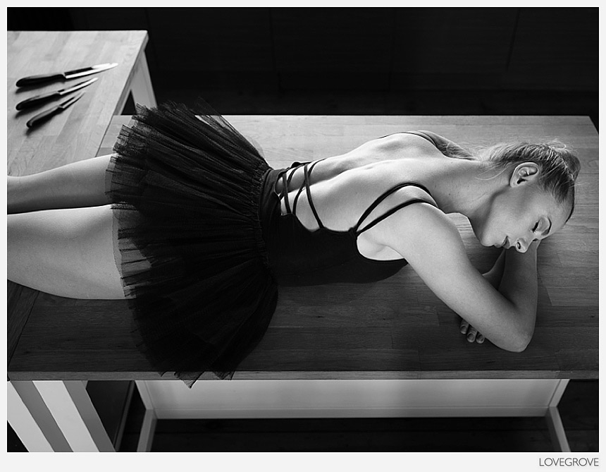 Ayla Rose lyes on a kitchen work surface beside knives.